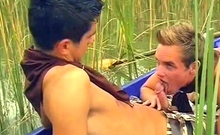 Hot boys rowing in a boat and sucking